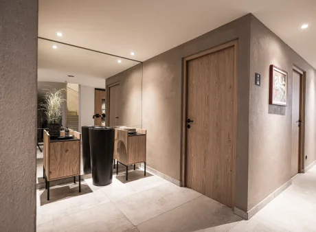 Waschraum mit Scheibenputz in hellem braun, raumhoher Spiegel, Waschtische davor.